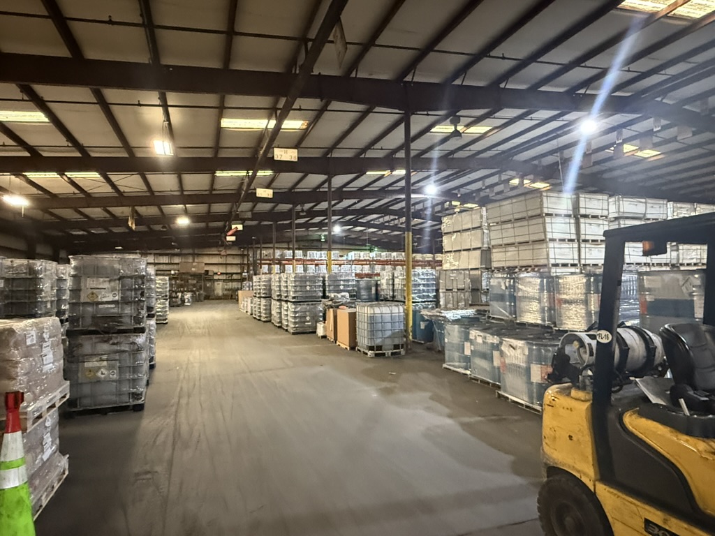Wide aisle inside Carroll's 170K sq ft warehouse with forklift and totes