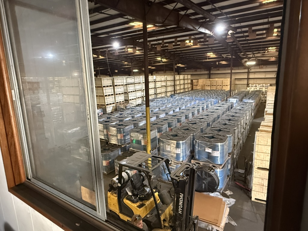 Rows of sealed drums staged inside Carroll's Norfolk warehouse