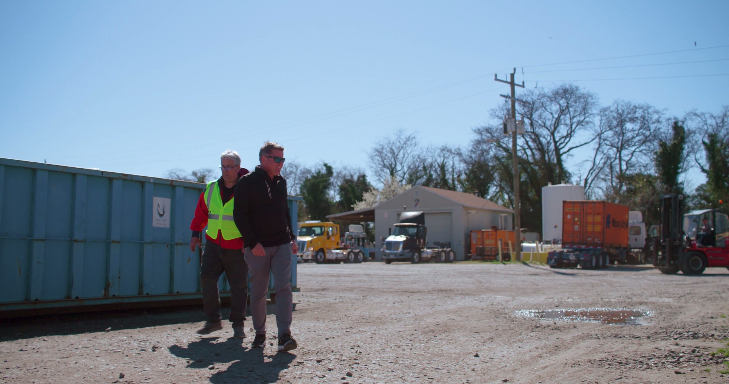 Matt Carroll walking the yard with a Carroll team member in a safety vest
